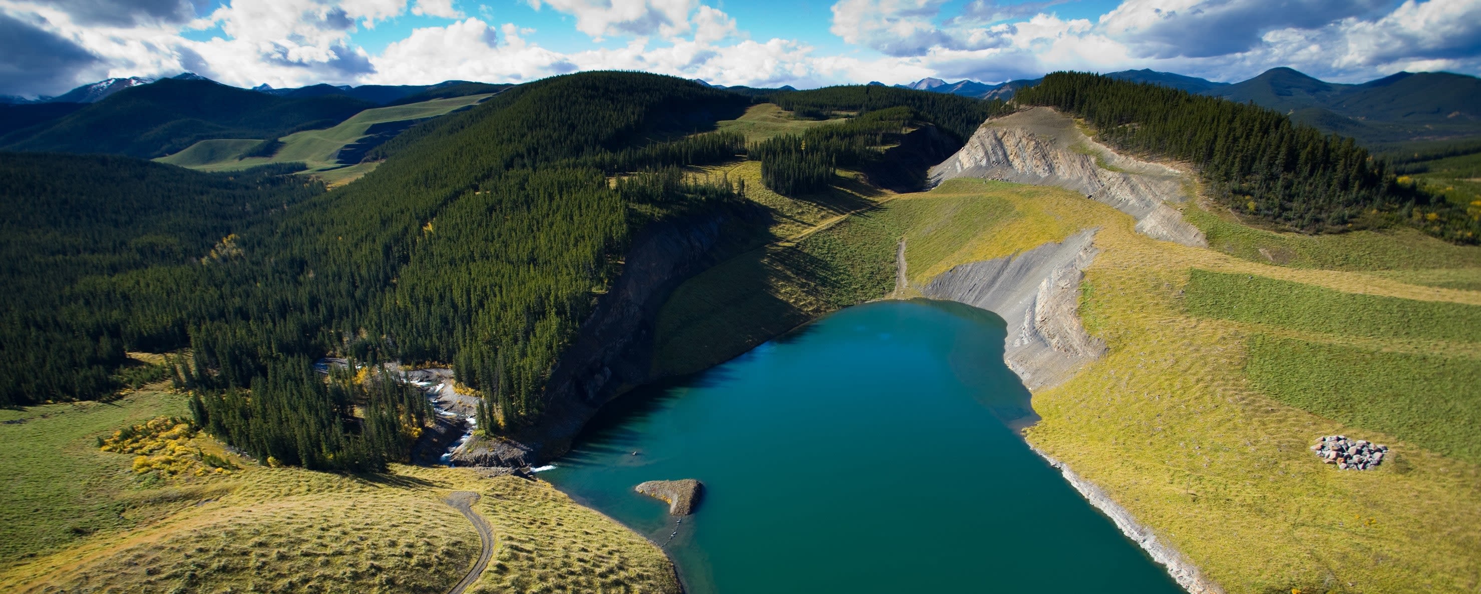 Sphinx lake, Canada. Blue lake in a pit, surrounded by green slopes
