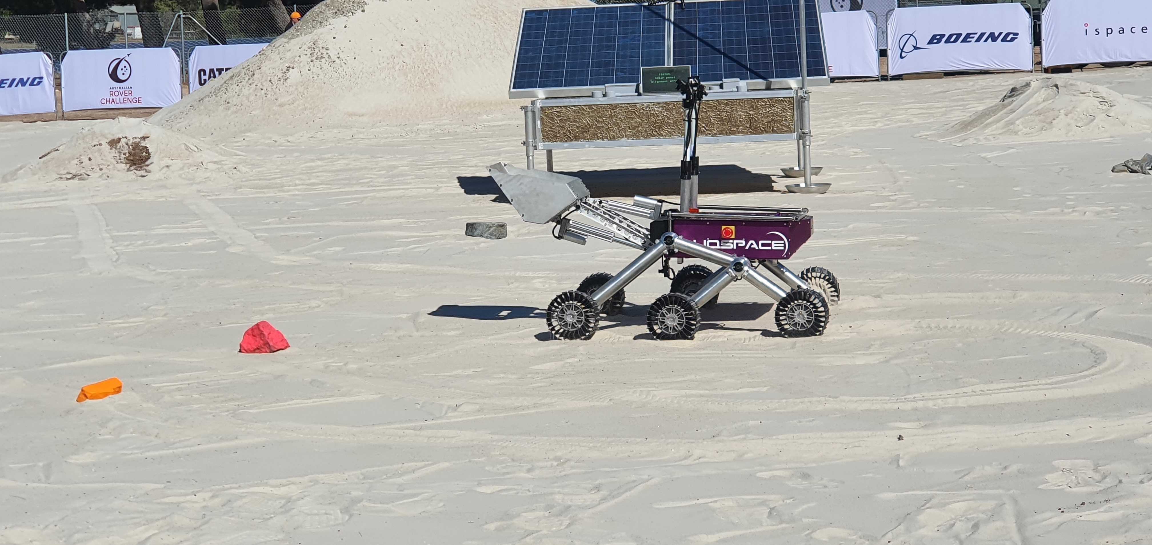 A rover vehicle on a sandy field