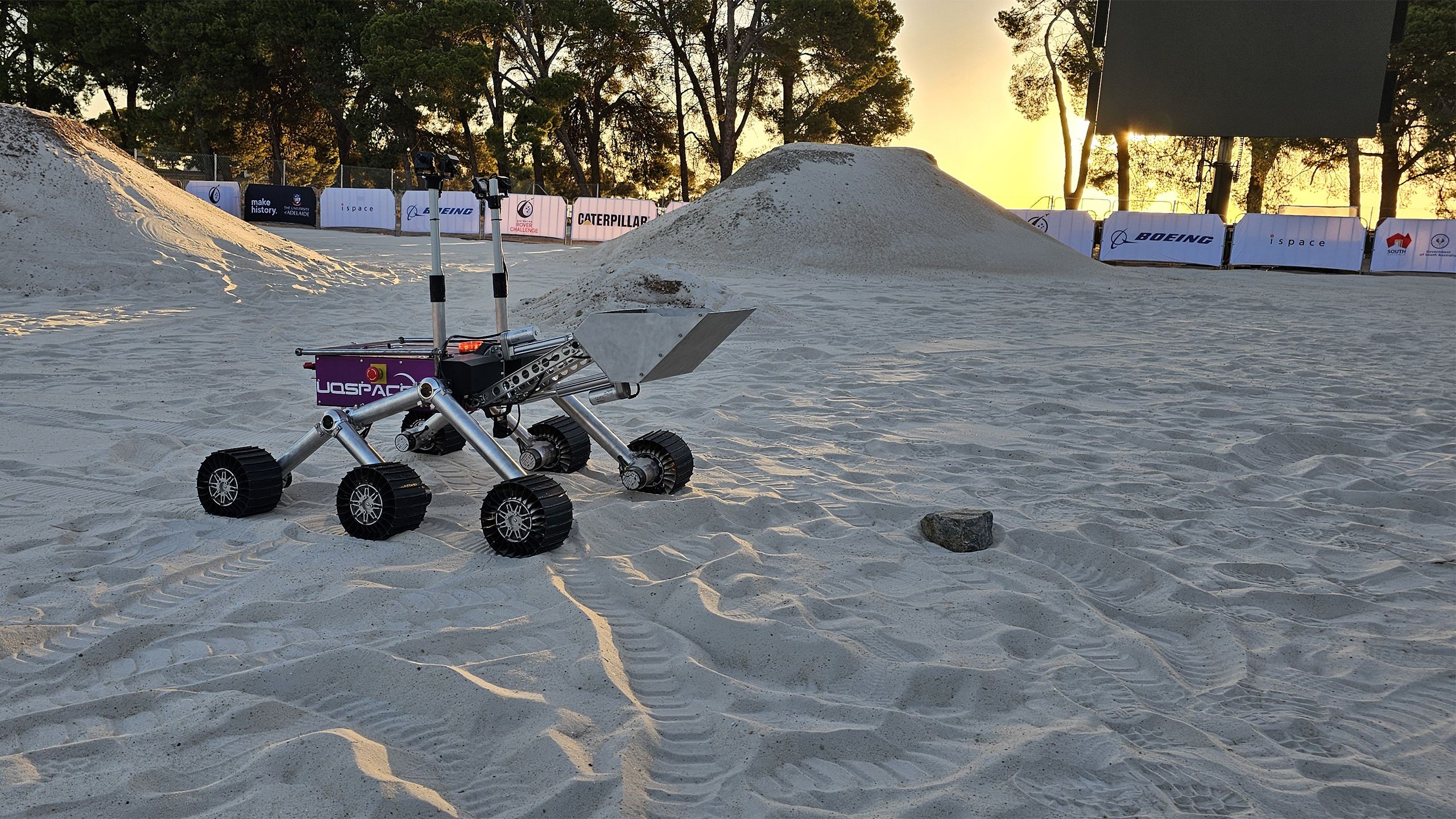 A six-wheeled buggy on sand