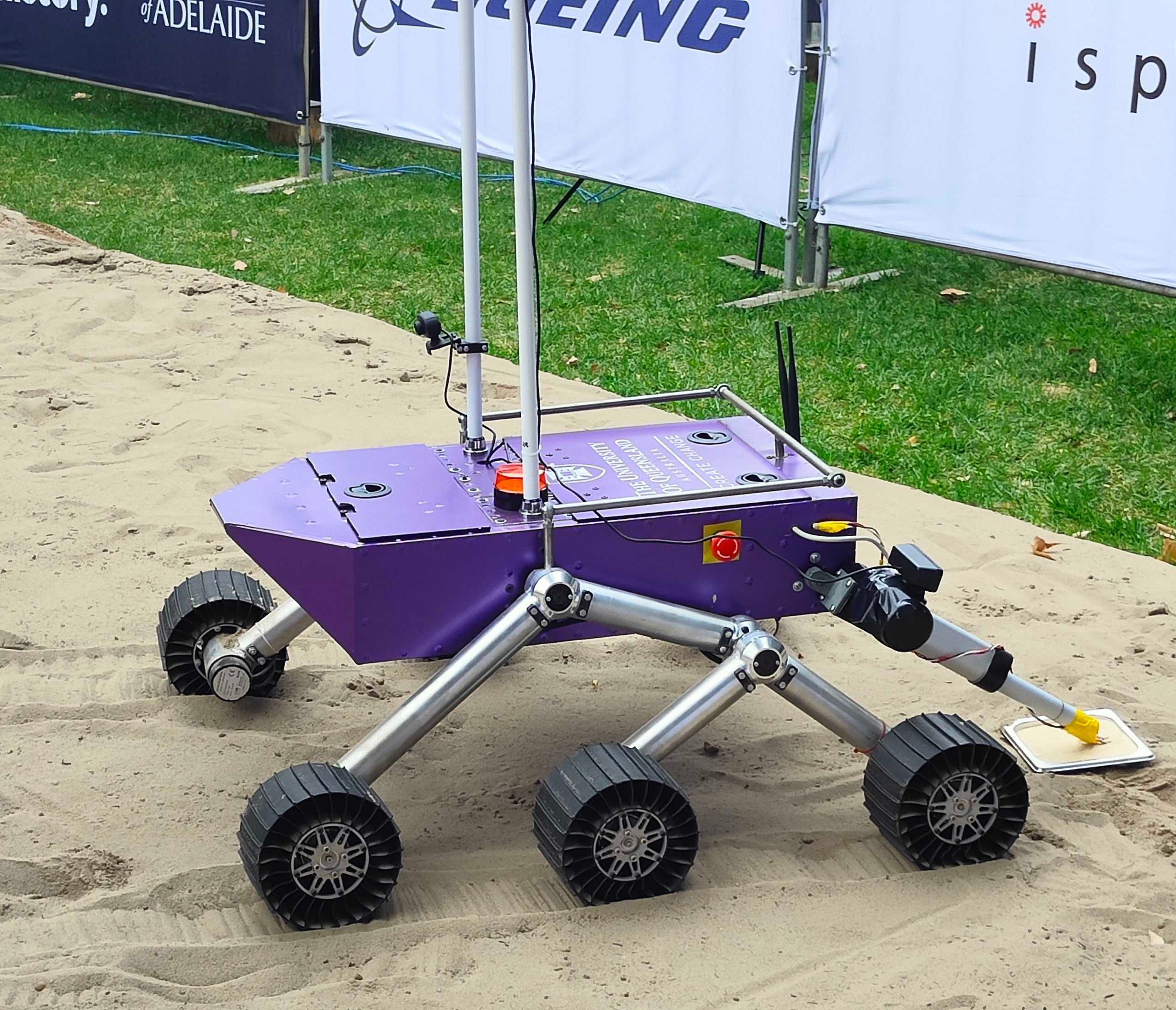 A close up on the wheels and body of a six-wheeled rover vehicle