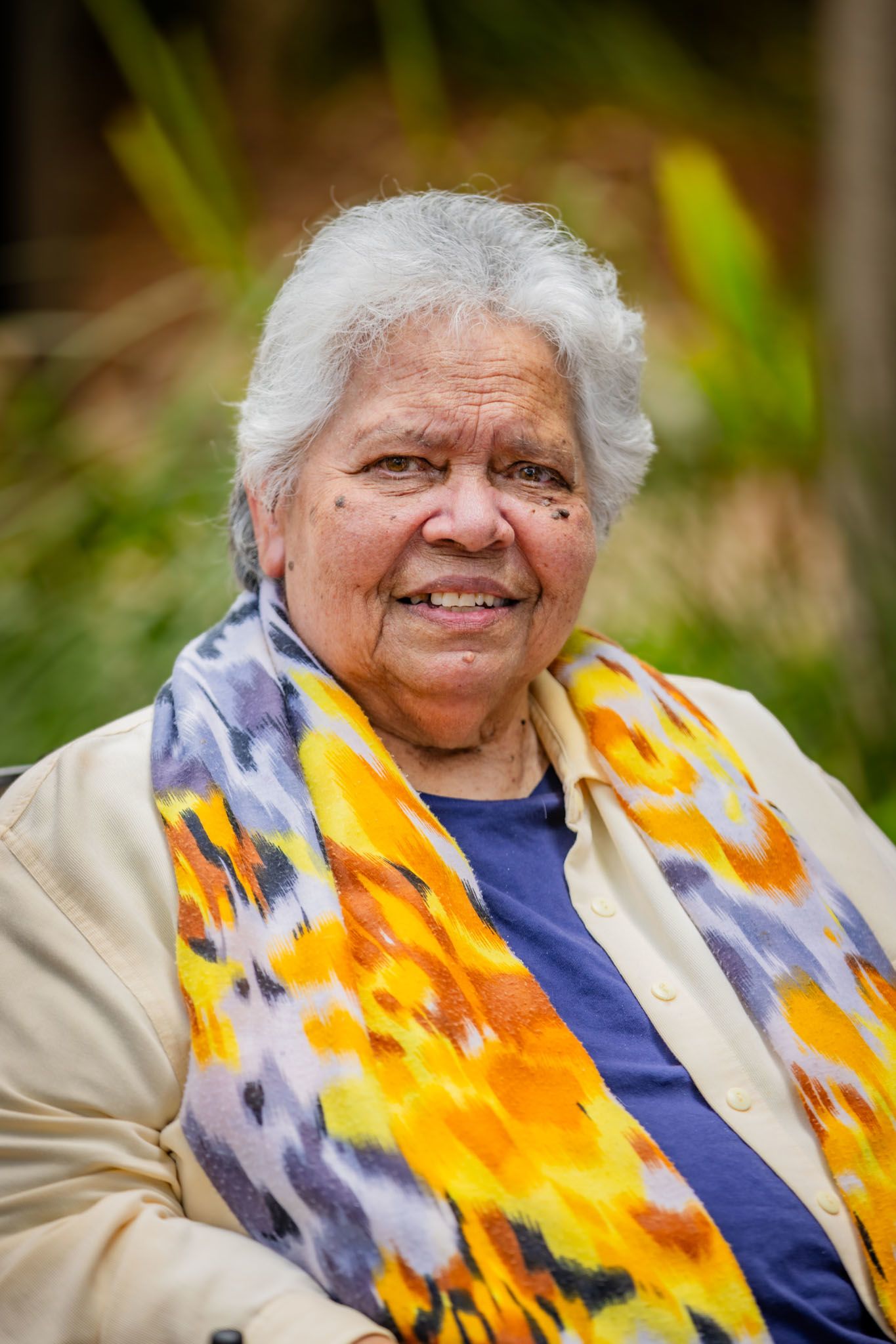 Photo of Aunt Lilla Watson wearing a yellow and blue scarf and cream top. 