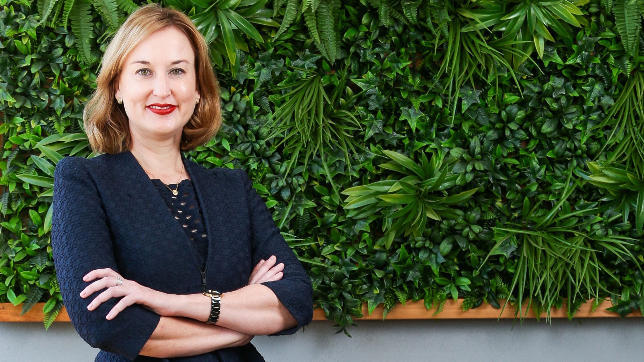 Margaret Lawson in front of a garden wall