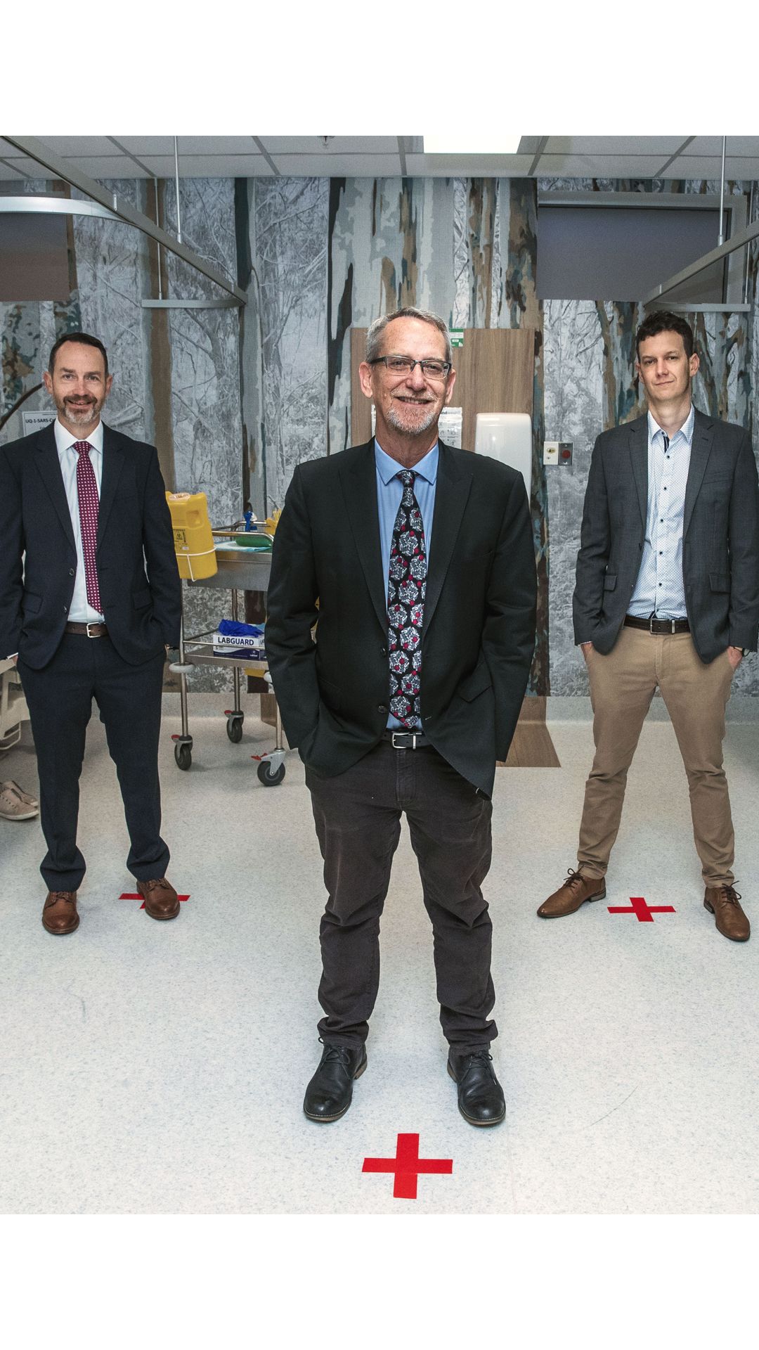 UQ's vaccine research team standing in the hospital while the first dose is administered in the human trial