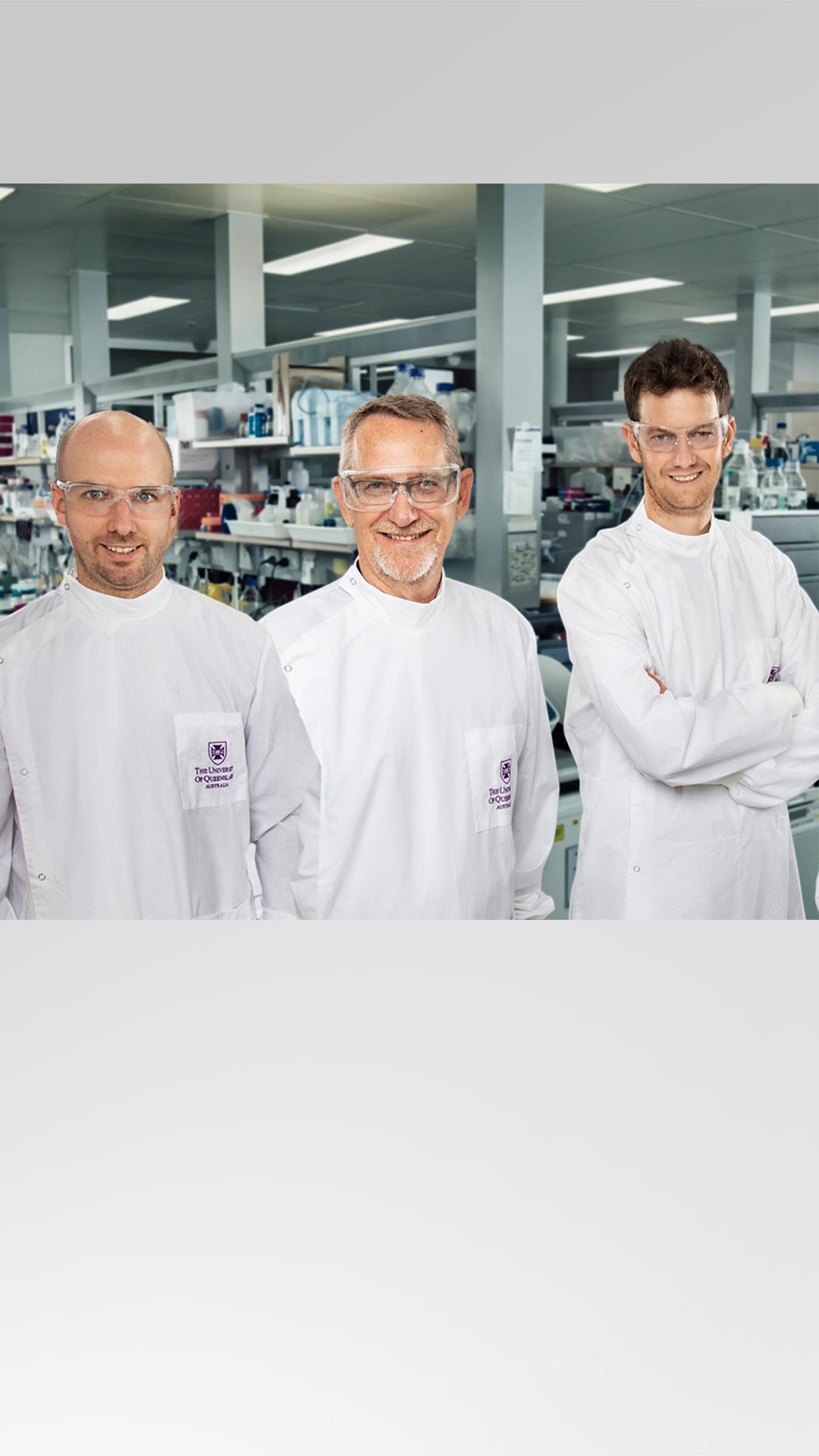 Dr Watterson, Professor Young, Associate Professor Chappell wearing a lab coat and safety glasses in a research lab