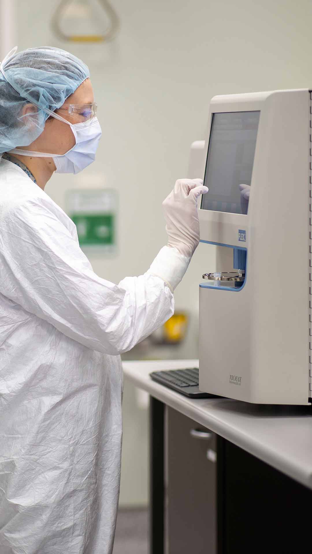 COVID-19 research lab. Women working in lab coat, mask and glasses