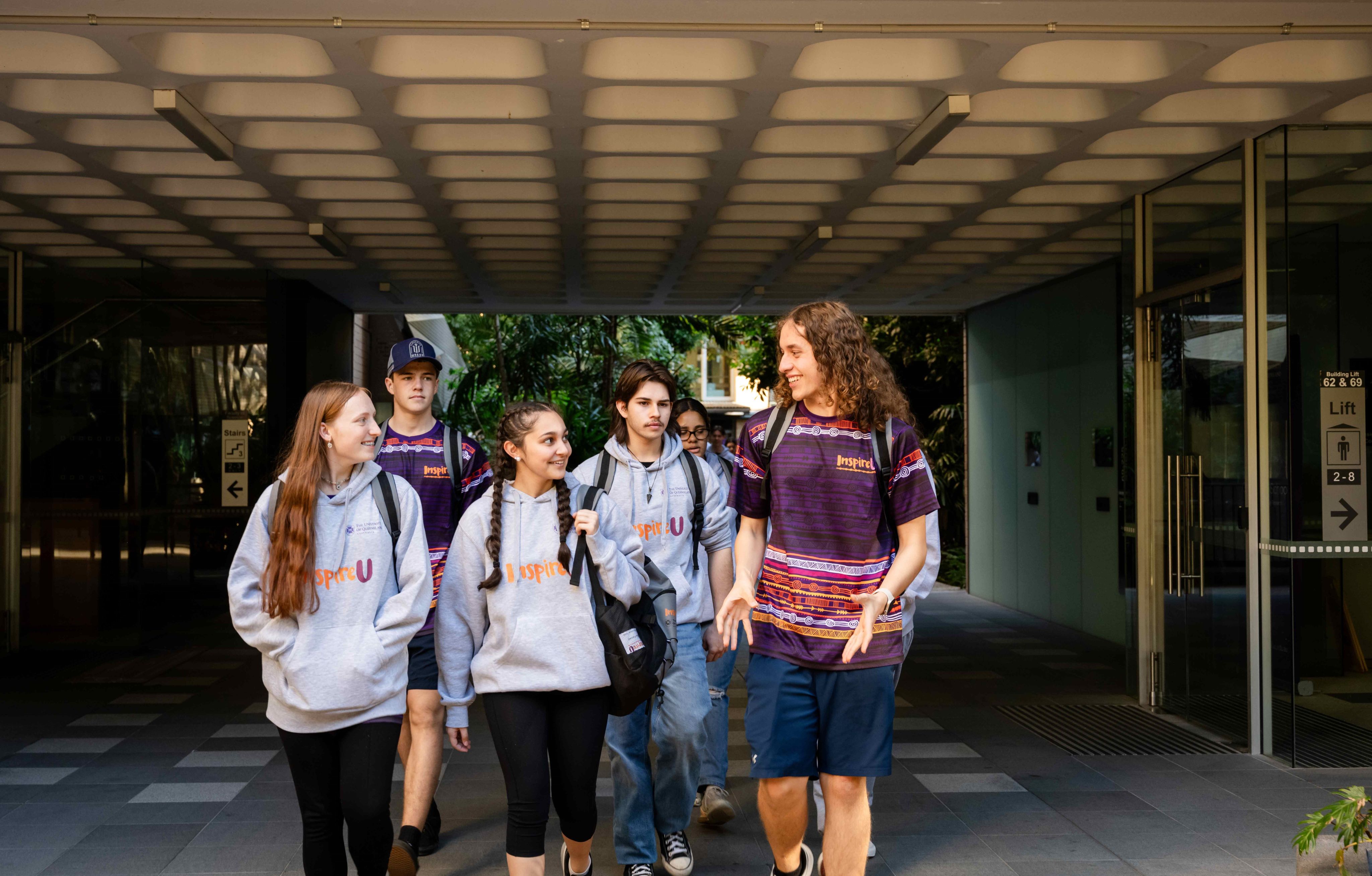 Angus (right) walks and talks to other students from InspireU.