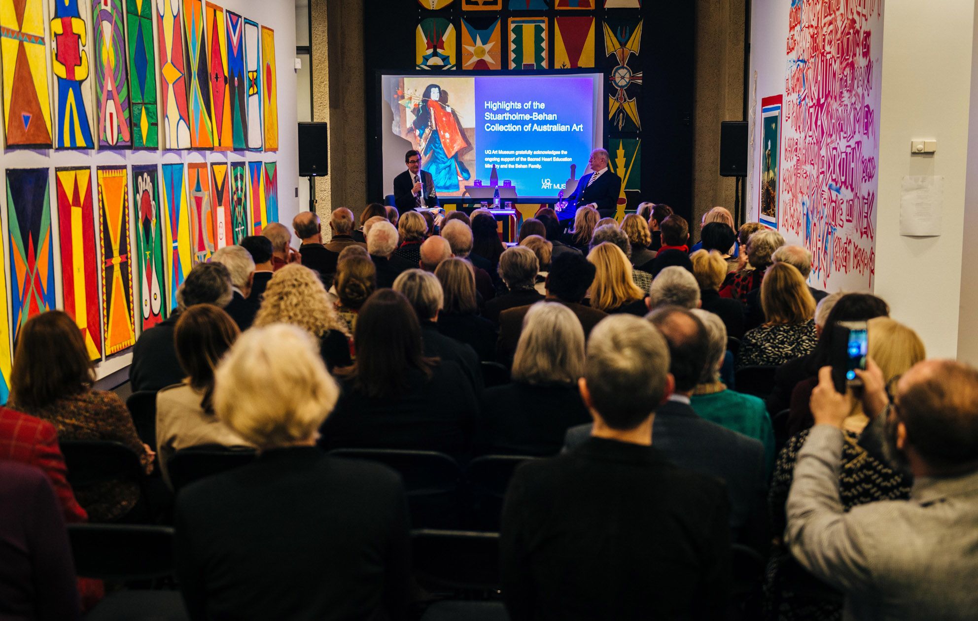 UQ Art Museum Director speaks with Dr Felix Behan about the Stuartholme-Behan Collection of Art in front of a gathered audience of donors.