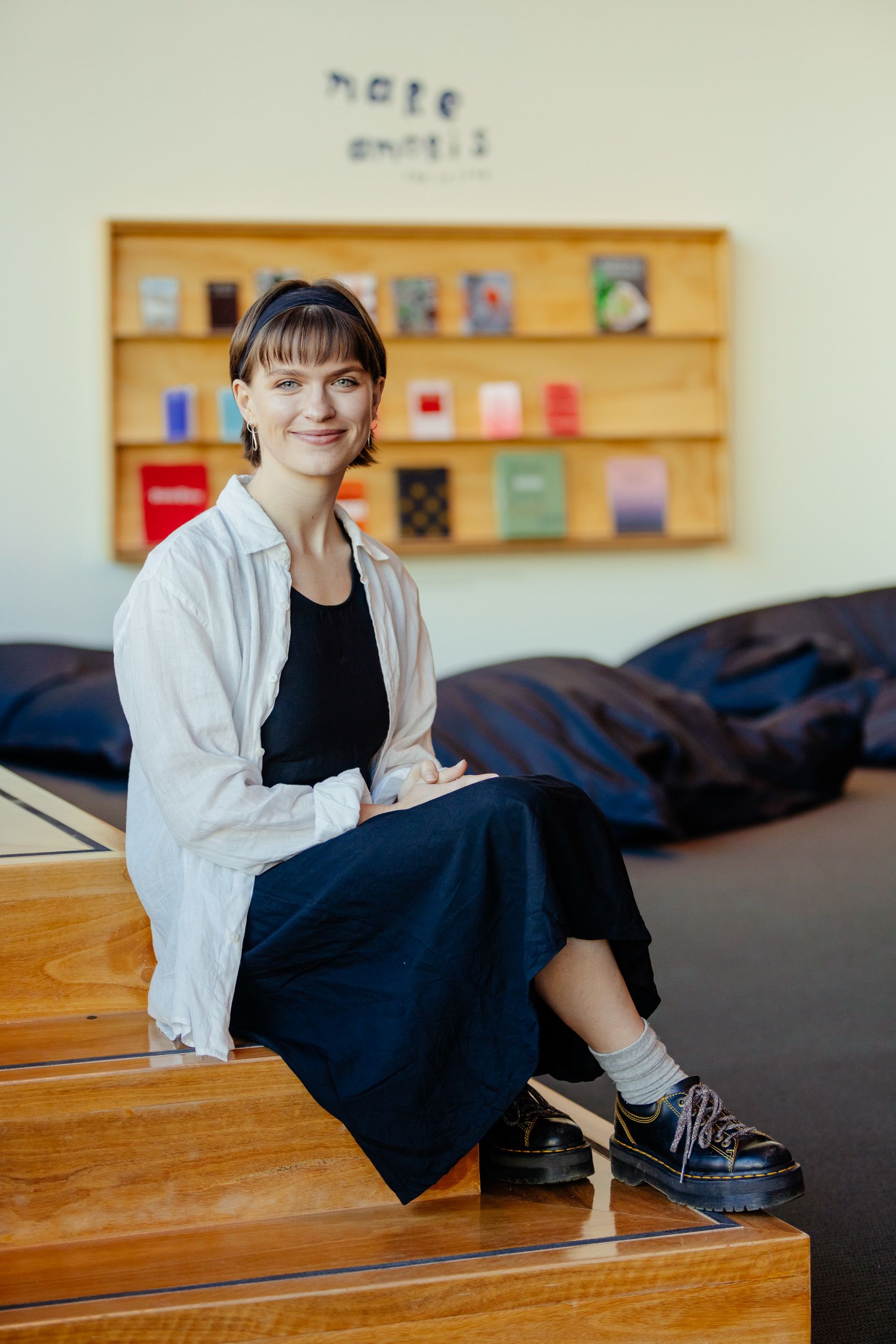 A person sitting on wooden steps and smiling