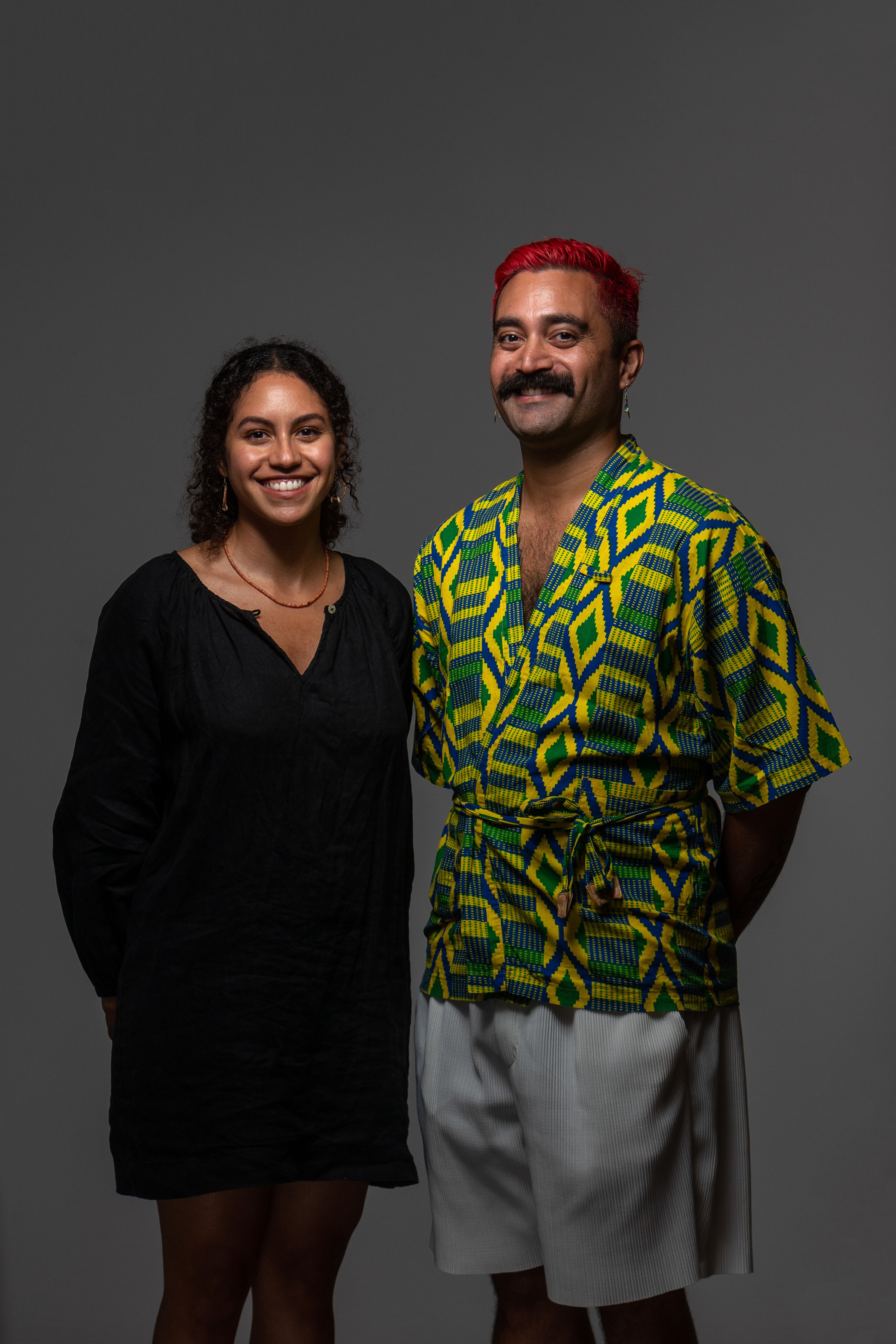 Two smiling people standing next to each other