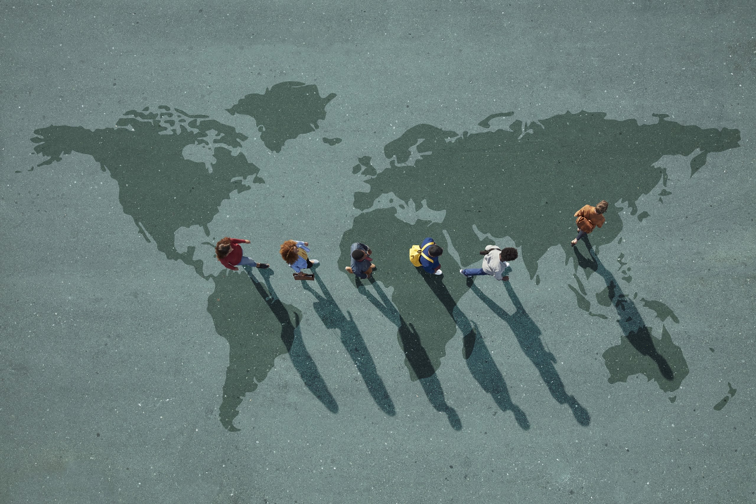 People following a leader across a world map.