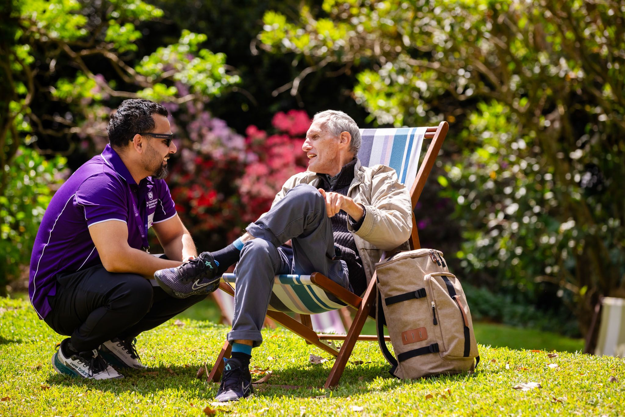 UQ staff member speaking to a community member