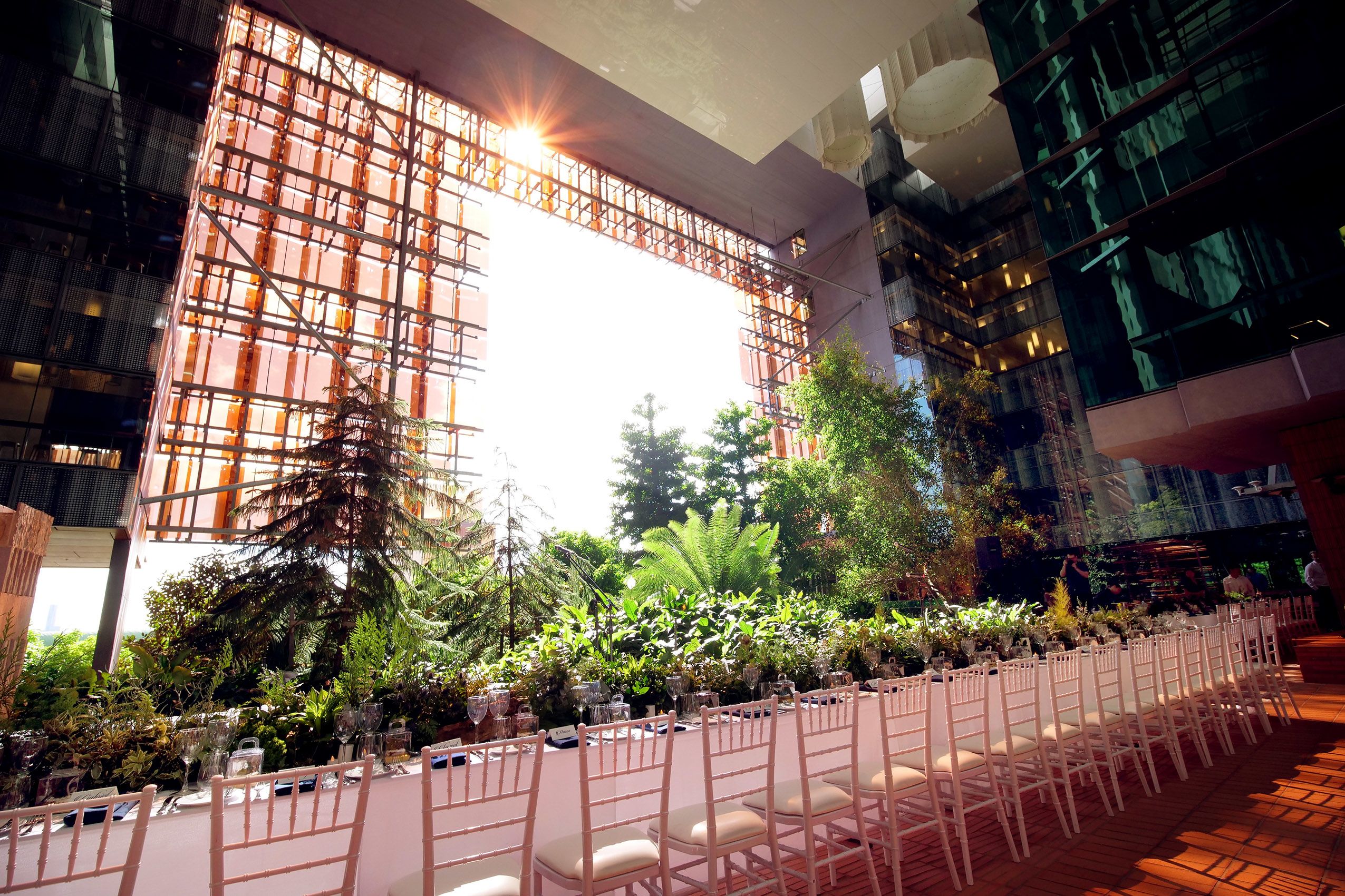 A long white table set amongst the greenery at the centre of the stunnign research institute.