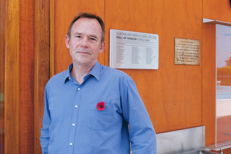 This is an image of UQ archivist Bruce Ibsen with the new World War I Roll of Honour plaque at the War Memorial Swimming Pool at UQ's Gatton campus.