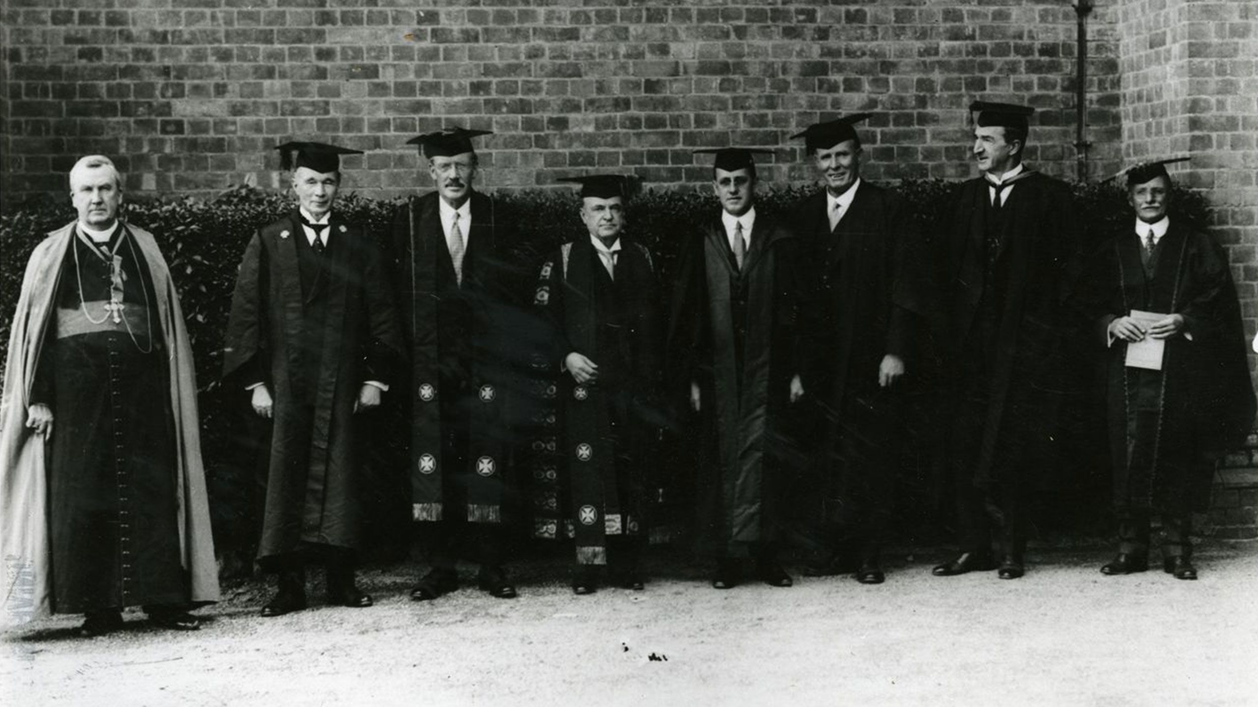 An image of a group of UQ officials in 1935. From left: The Most Reverend James Duhig, The Honourable Thomas Beirne, Dr William Robertson (Vice-Chancellor), The Honourable Sir James Blair (Chancellor), Professor Henry Alcock, Joseph McCaffrey, Professor Roger Hawken and William M L'Estrange.