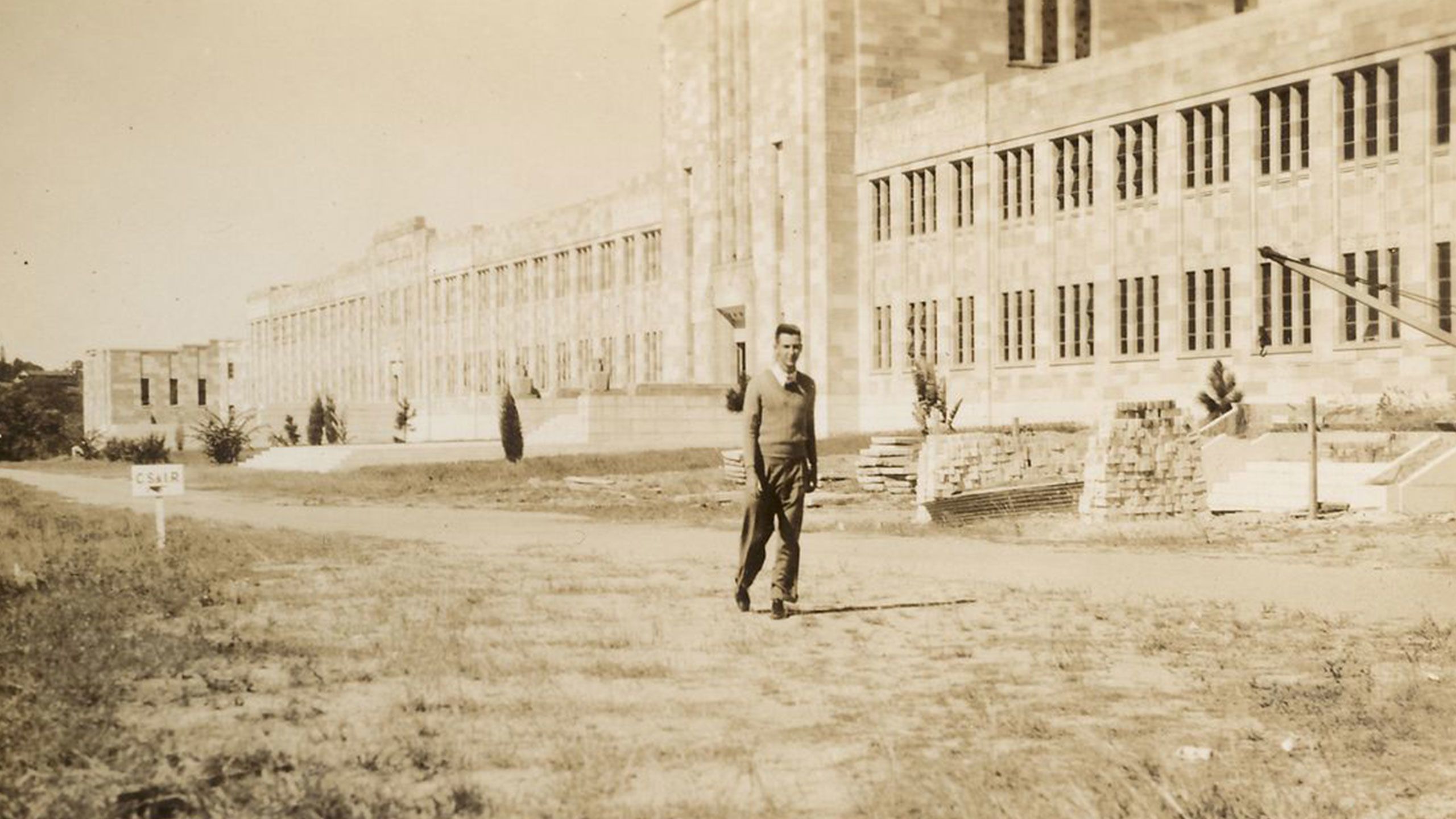 An image of Noel McElnea in front of the Forgan Smith building in 1948.