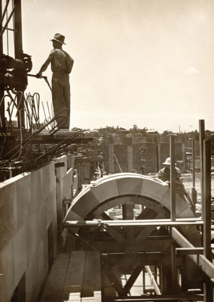 An image of Two construction workers installing the cloisters on the Forgan Smith building in 1940.
