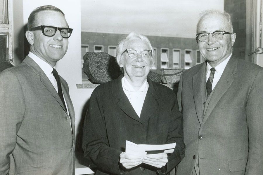An image of Professor Dorothy Hill and Professor Laurence Teakle receiving a donation from a representative of Esso in 1968.
