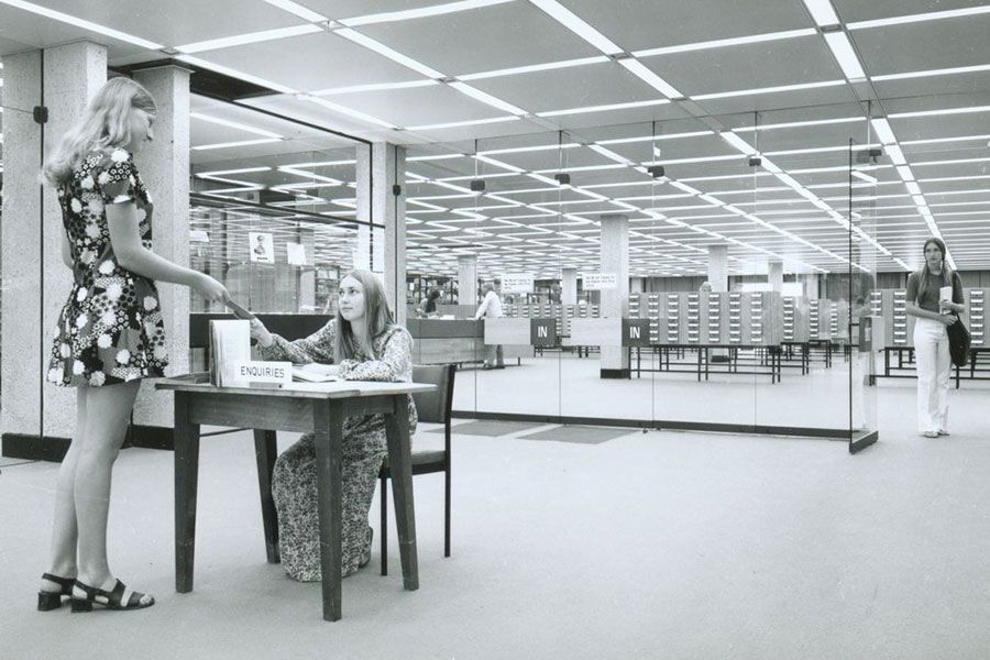A image of two students at the enquiries station in the Central Library in 1973.