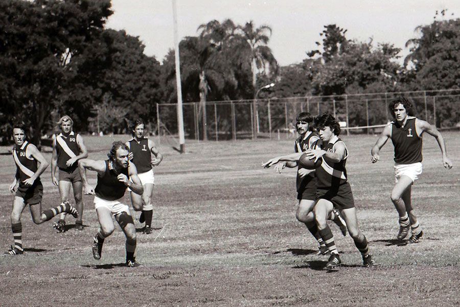 An image of the UQ Australian Rules Football team in action in 1975.