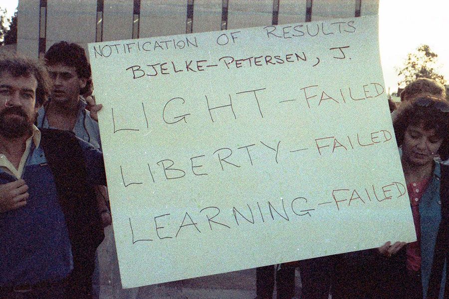 An image protesters holding a sign during an anti-Joh Bjelke-Petersen protest at UQ in 1985.