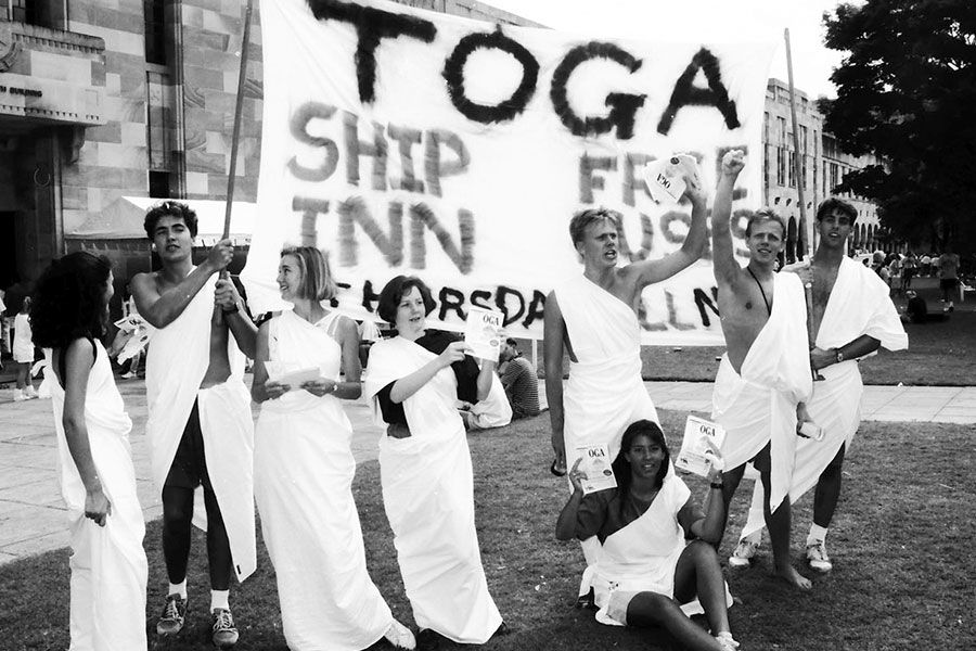 An image of students spruiking a toga party during O-Week in 1991.