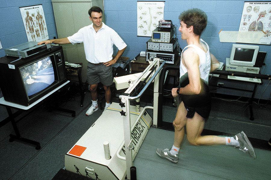 An image of three-time Olympic sailor and UQ graduate Michael Blackburn (left) working with an athlete as part of his PhD in Human Movement Studies in 1994.