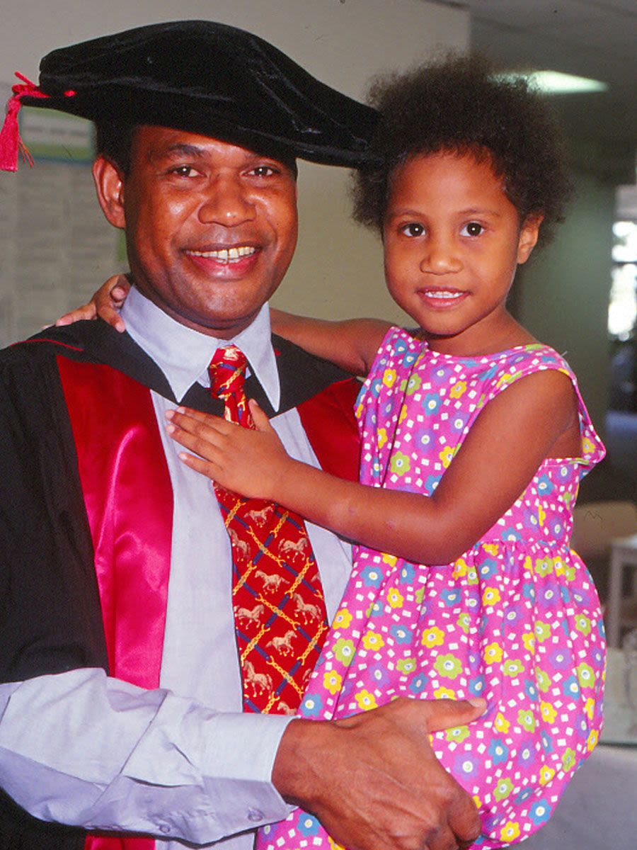 UQ graduate Peter Sapak with his daughter at his graduation day in 2000.