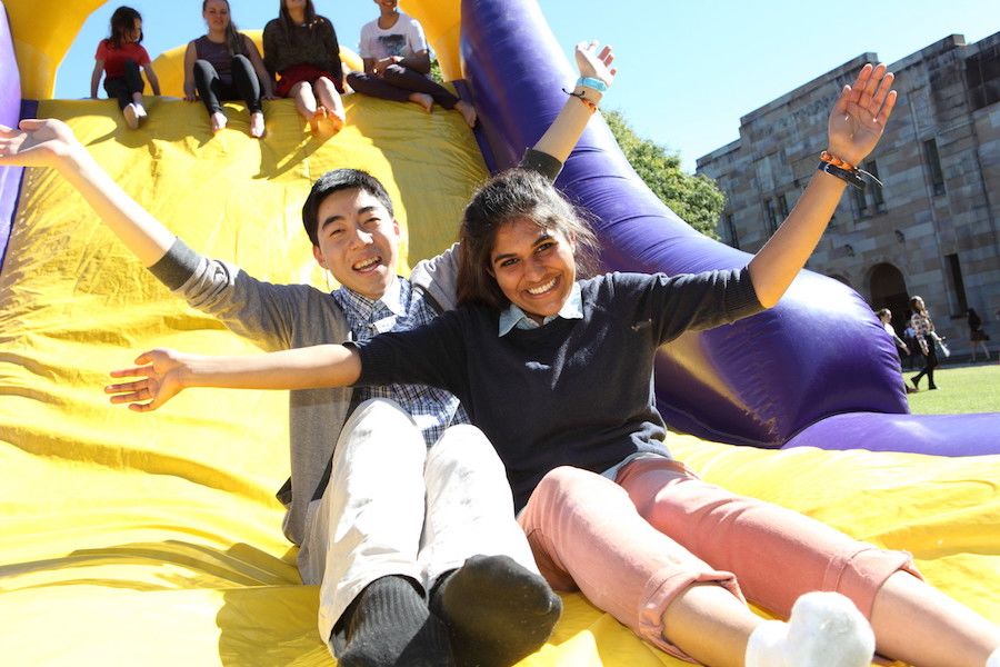 An image of two people sitting at the bottom of an inflatable slide at UQ St Lucia in August 2013.