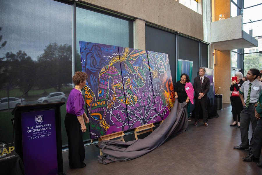 An image of an artwork being uncovered in the UQ Art Museum in 2019.