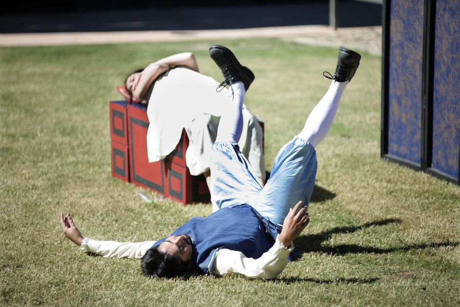 An image of two actors cavorting on the grass at UQ St Lucia in August 2012.