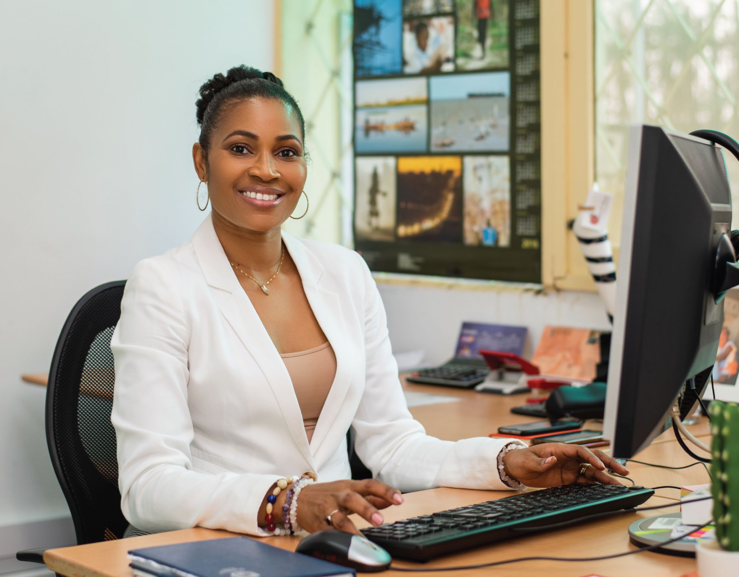 An image of UQ International Alumnus of the Year award recipient Fauna Ibramogy (Master of Agribusiness, 2013) sitting at her desk and working on her computer.