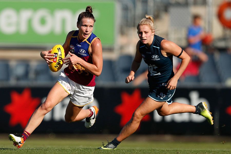 An image of UQ graduate and Brisbane Lions AFLW star Emily Bates in action against Carlton.