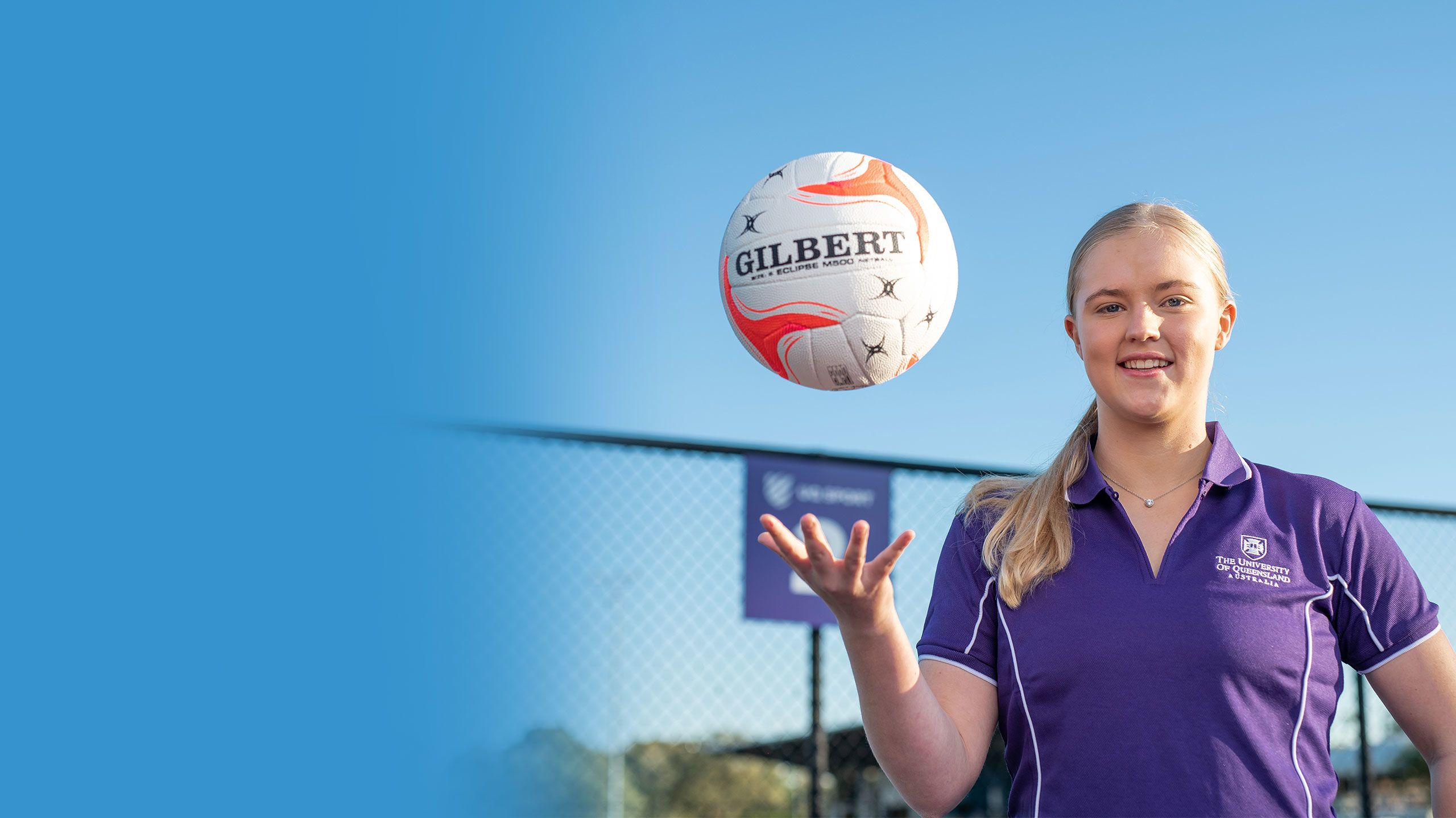An image of UQ Firebirds Scholarship recipients Savanna Detlefson throwing a netball up and down.