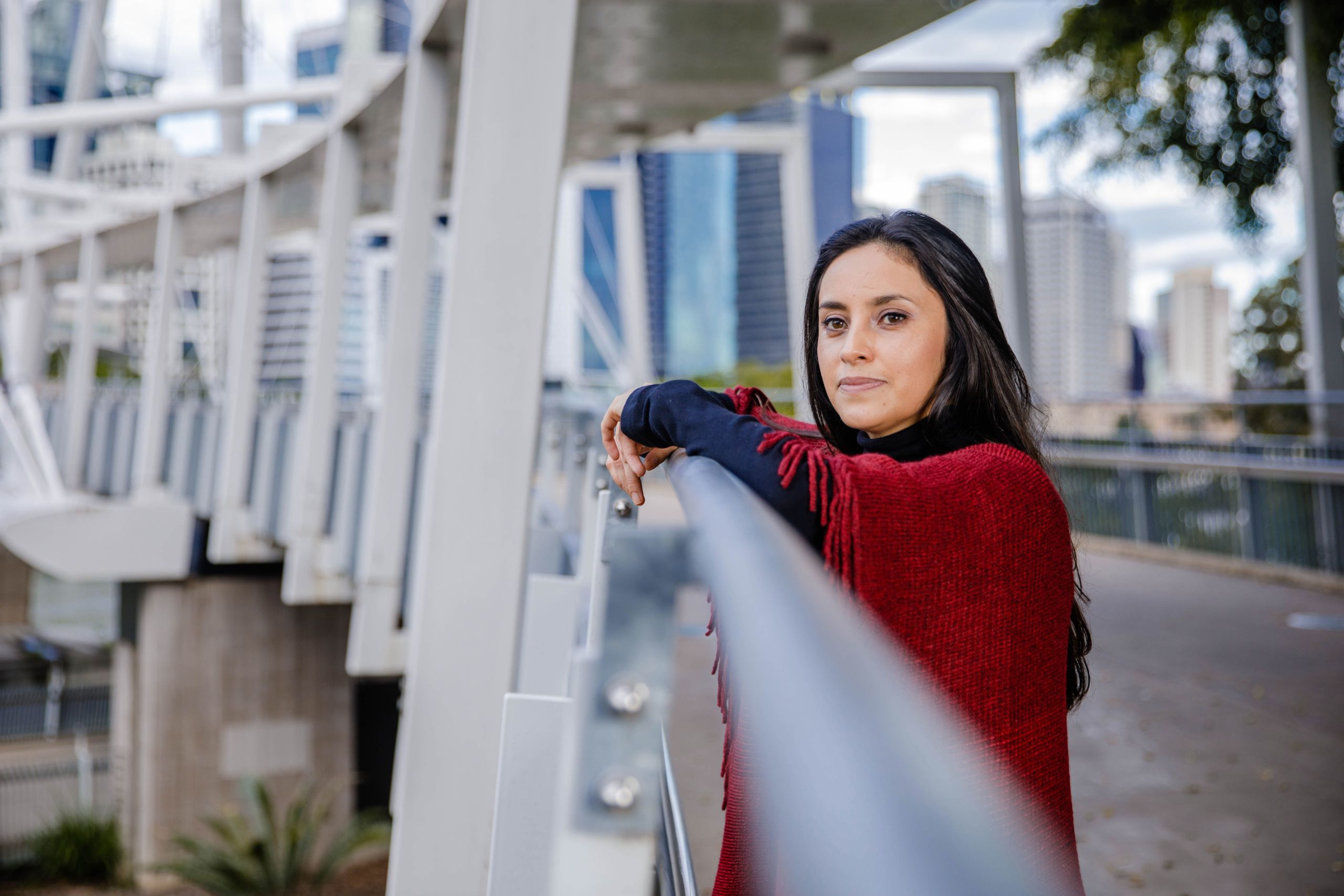 An image of UQ researcher Dr Astrid Rodriguez-Acevedo standing on the Kurilpa Bridge in Brisbane.