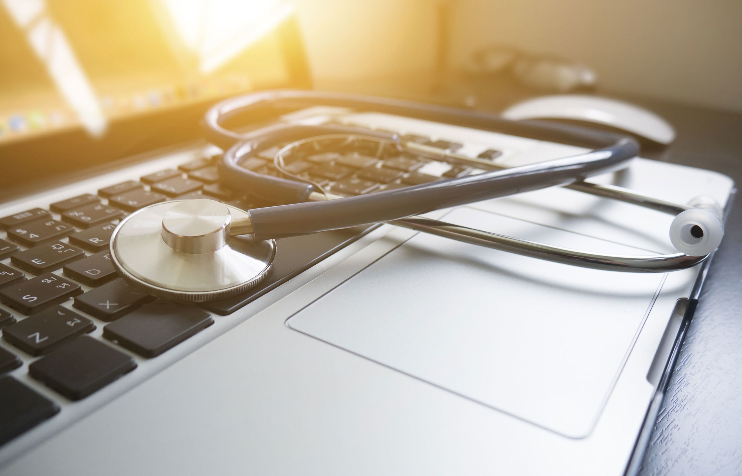 This is an image of a Stethoscope on laptop keyboard.