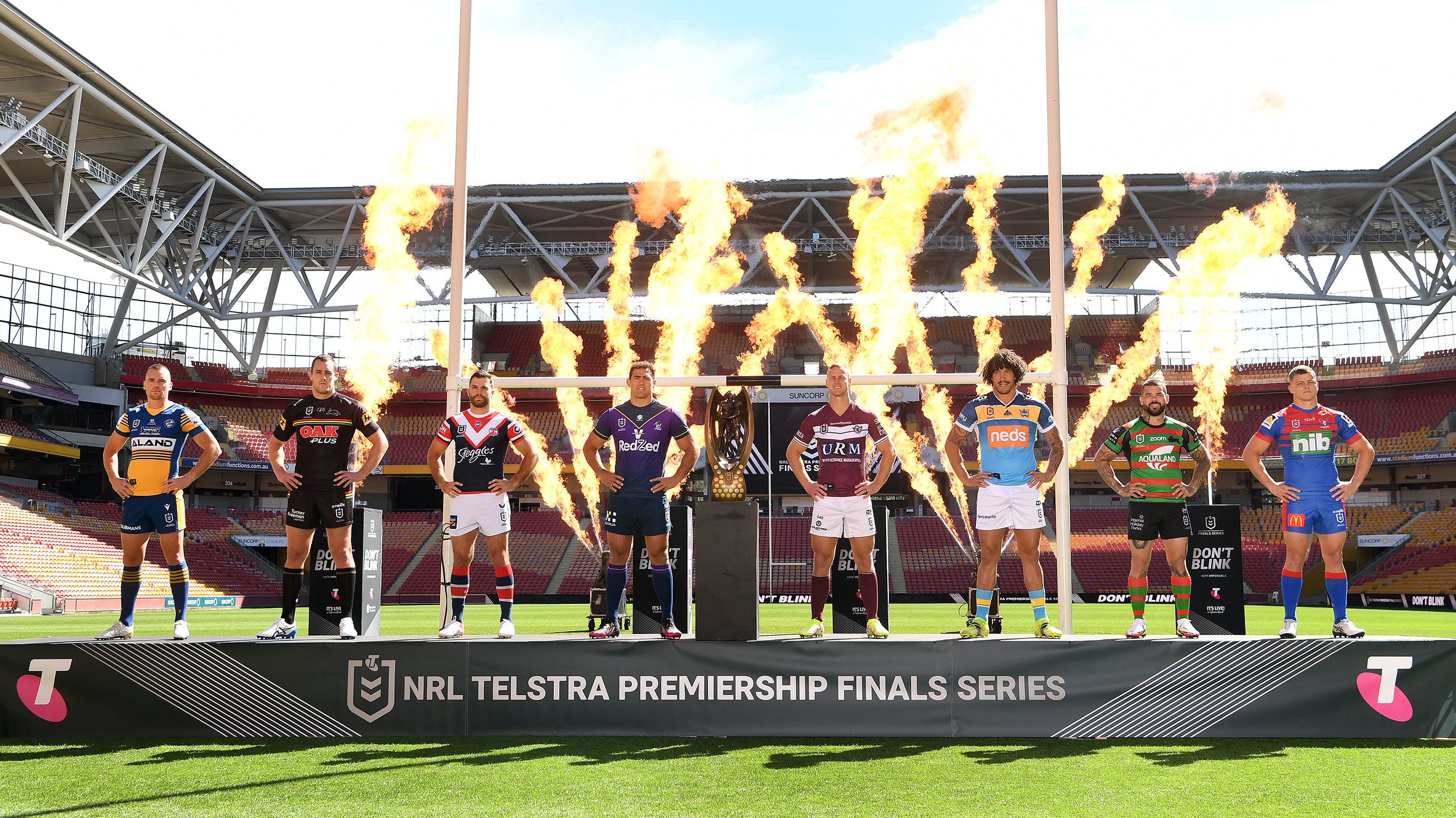 An image of the captains of the eight NRL teams competing in the 2021 finals series. The image is taken at Suncorp Stadium in Brisbane.