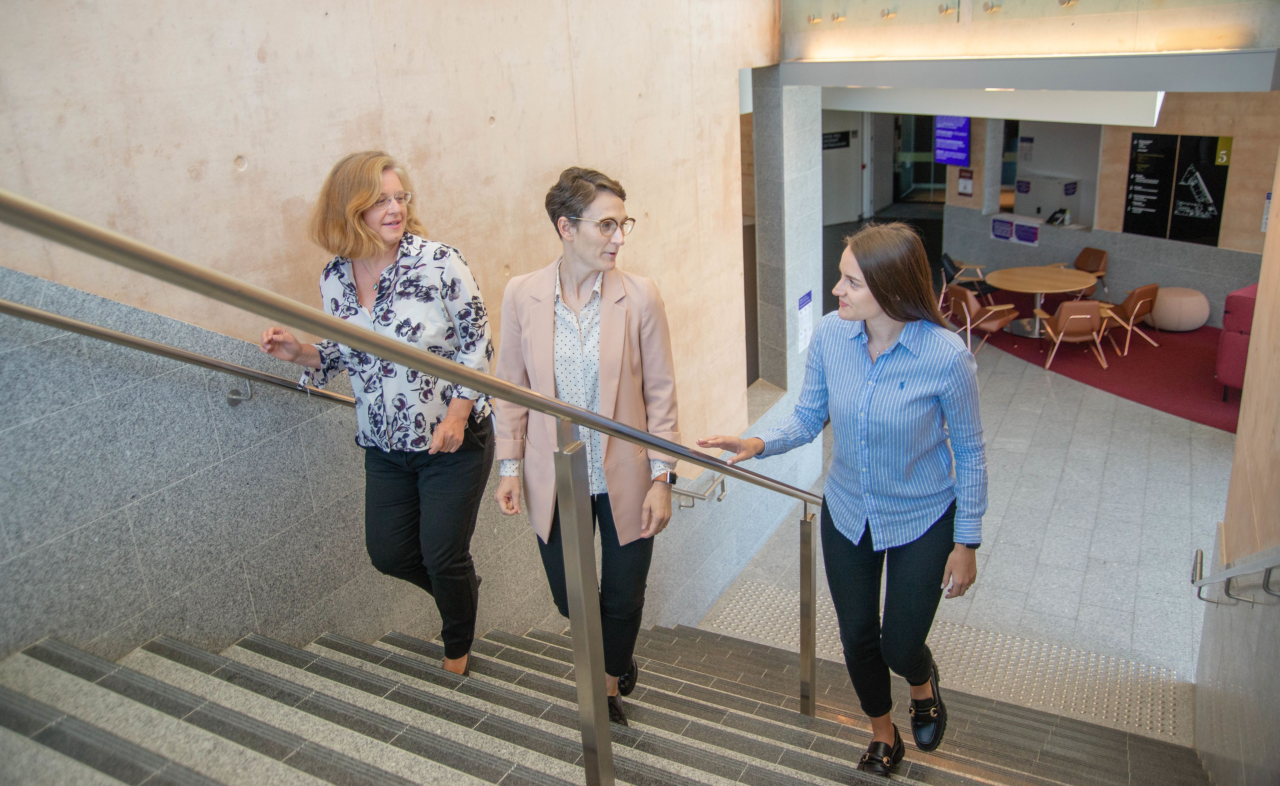 Dr Sabine Matook, Dr Angie Knaggs and Lara Harbers walking up the stairs together