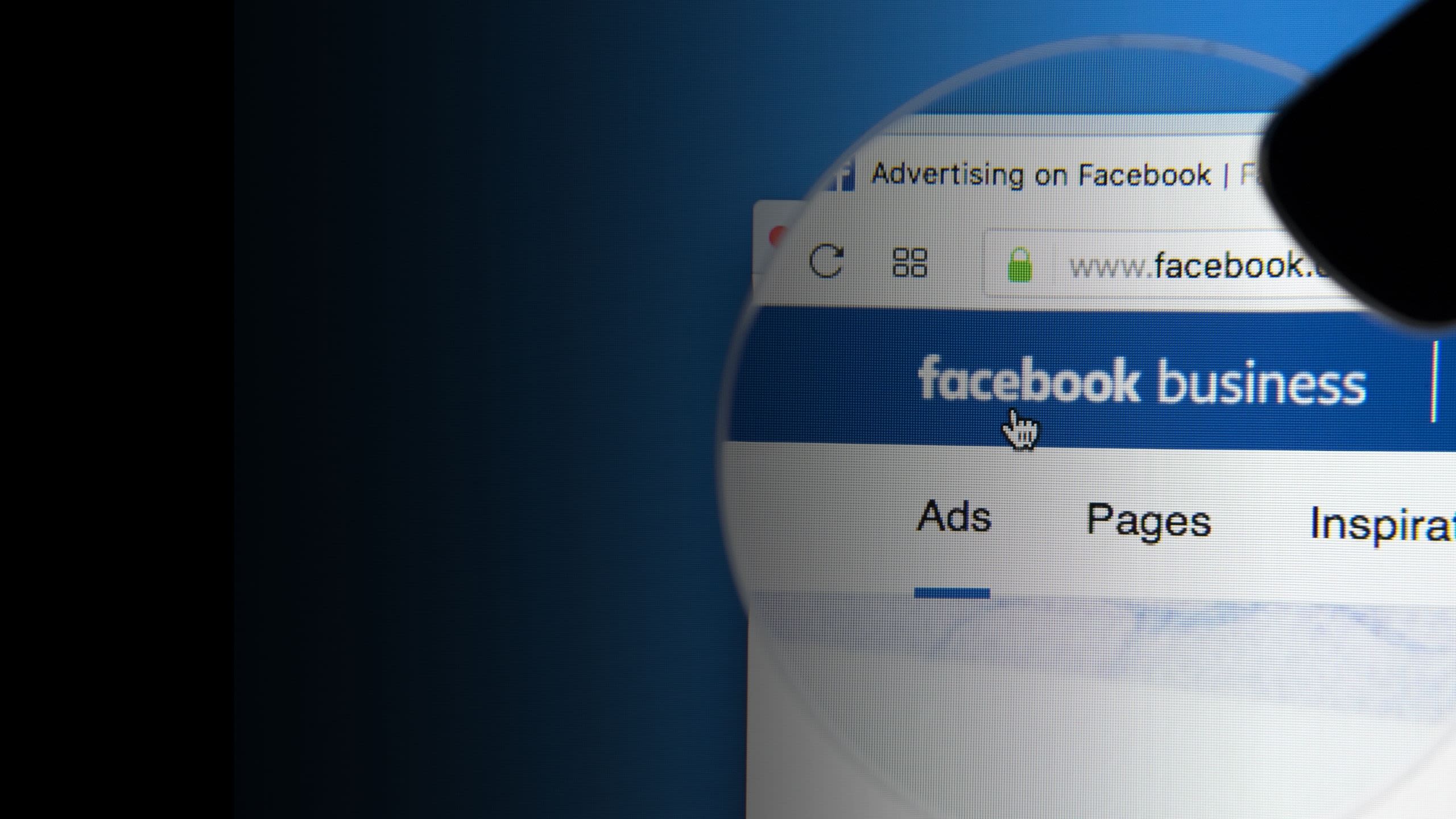 Facebook Business page with a magnifying glass over the Ads tab against a blue background.