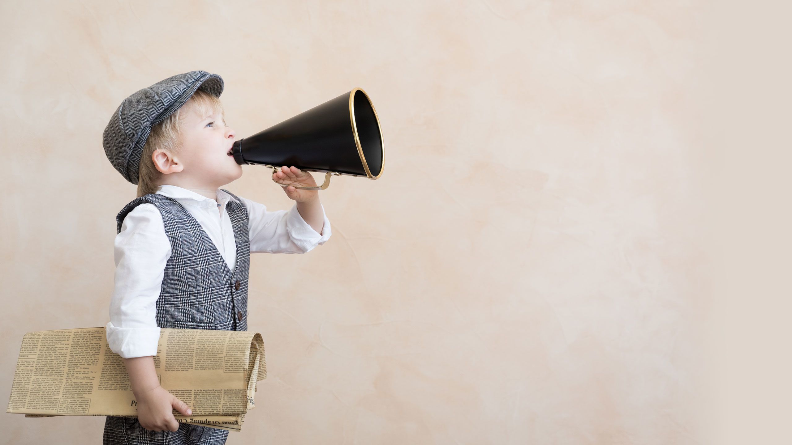 An image of a young boy spruiking newspapers