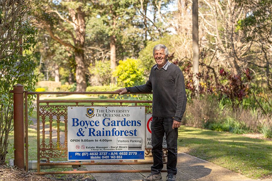 An image of Daryl Mears outside the gates of Boyce Gardens, which was gifted to The University of Queensland in 1969.
