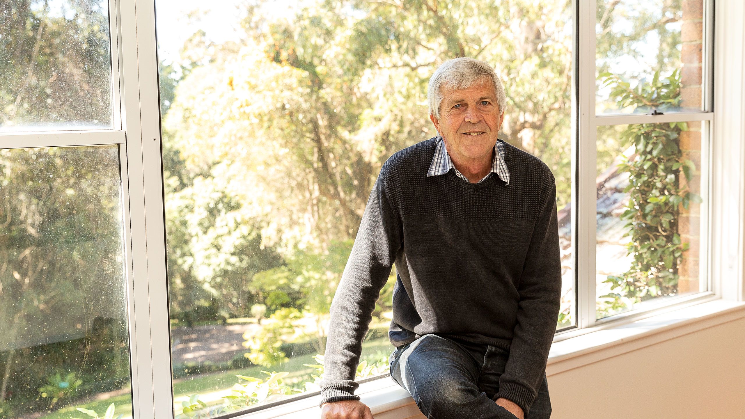 An image of Daryl Mears sitting by a window inside the Boyce Gardens house