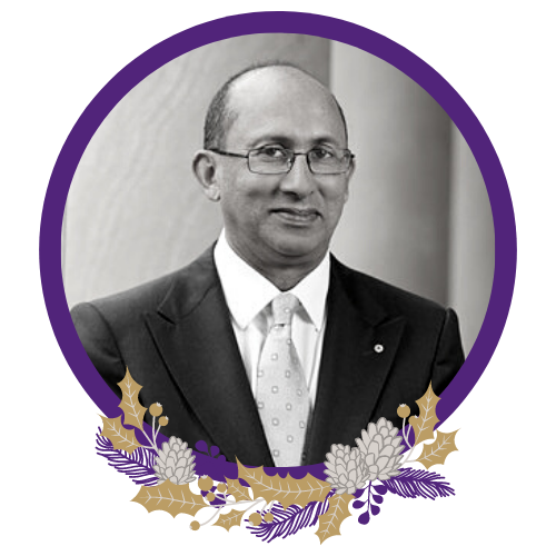 Black and white image of Peter Varghese AO. The image has a purple circular border with a purple and gold native wreath at the bottom.