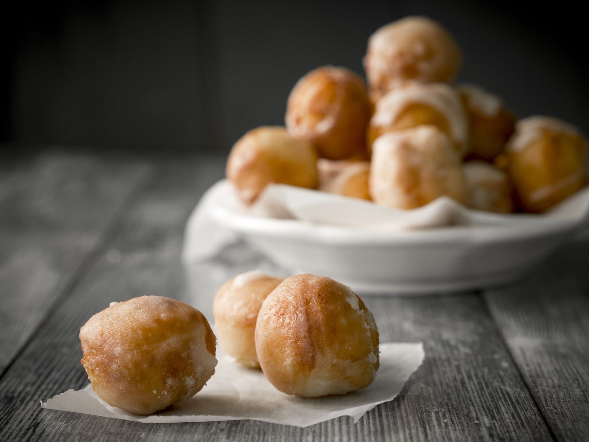 Indian donuts (gulgula) against a dark background.