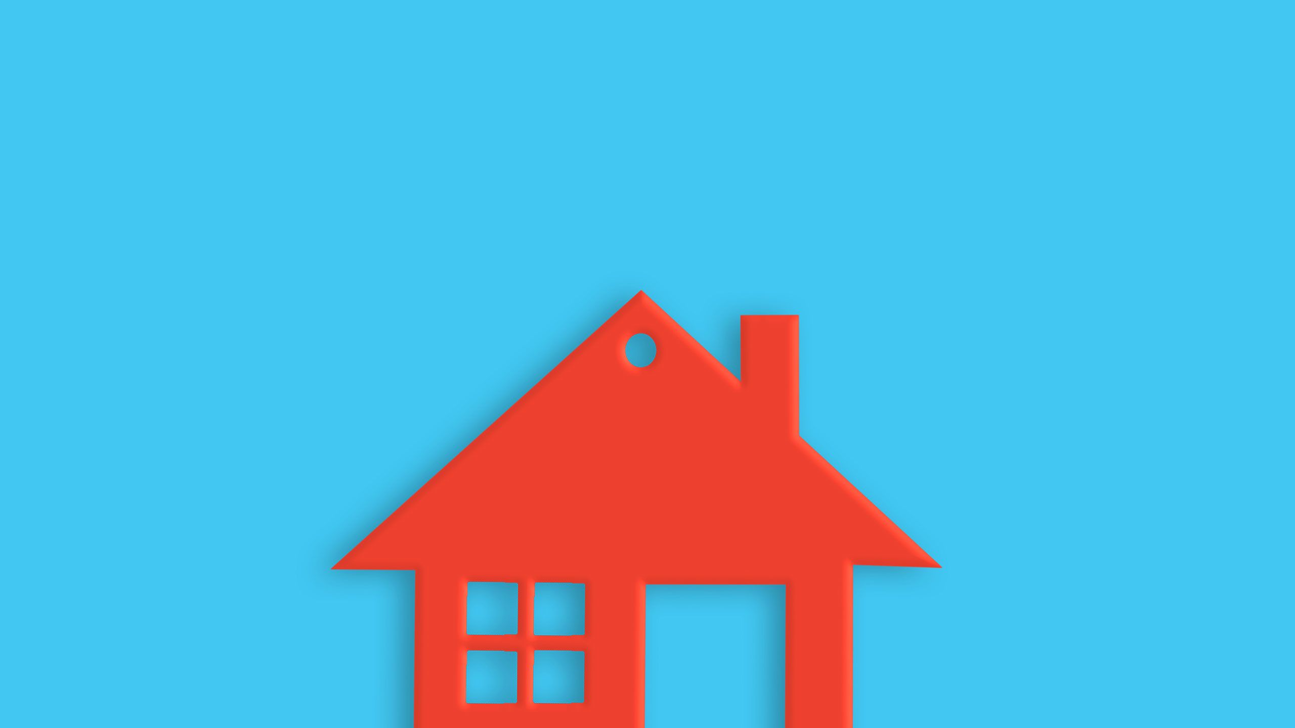An image of one red plastic house with window and door on blue table.