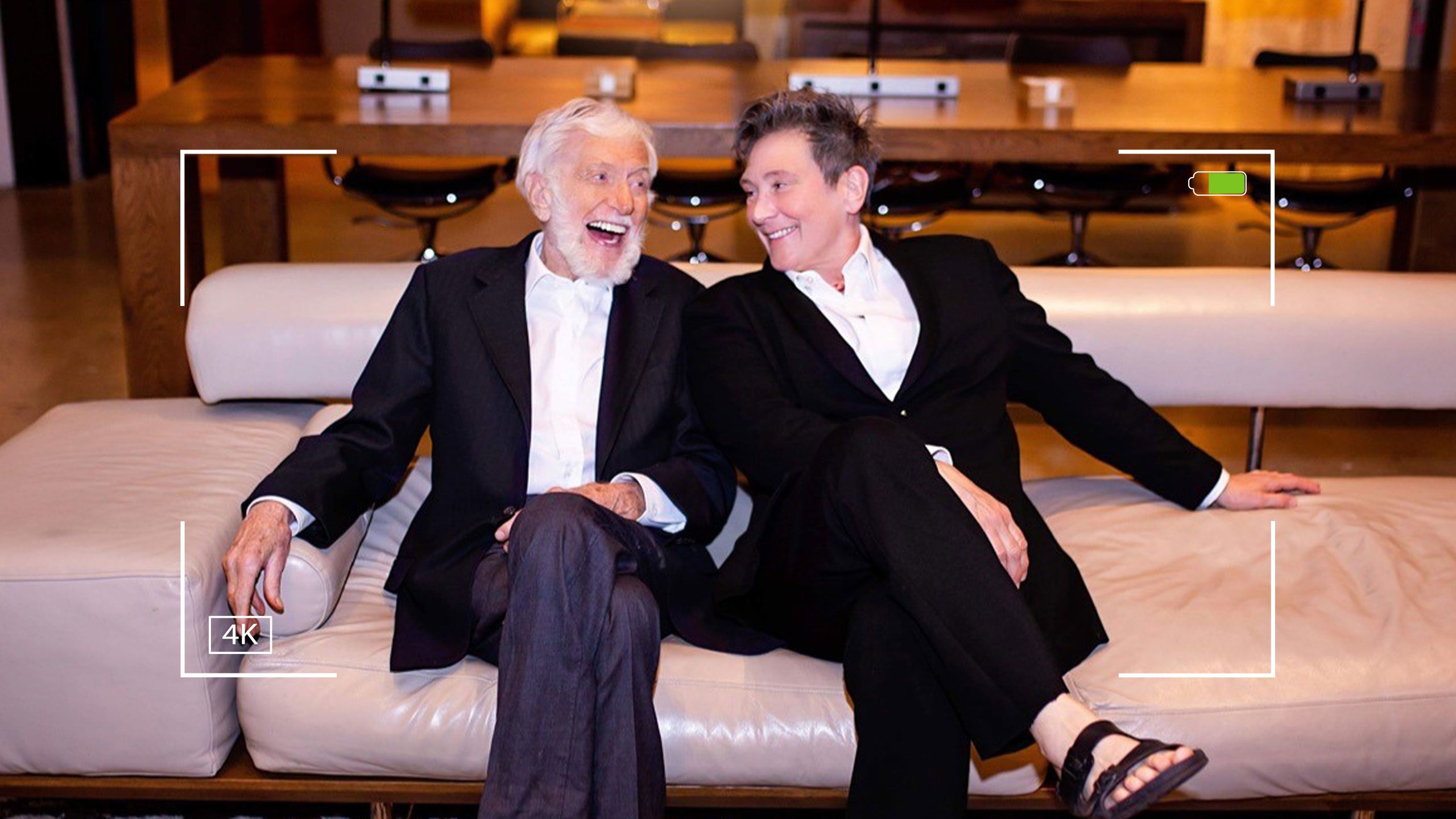 An image of Dick Van Dyke sitting on a couch talking to with singer K.D. Lang.
