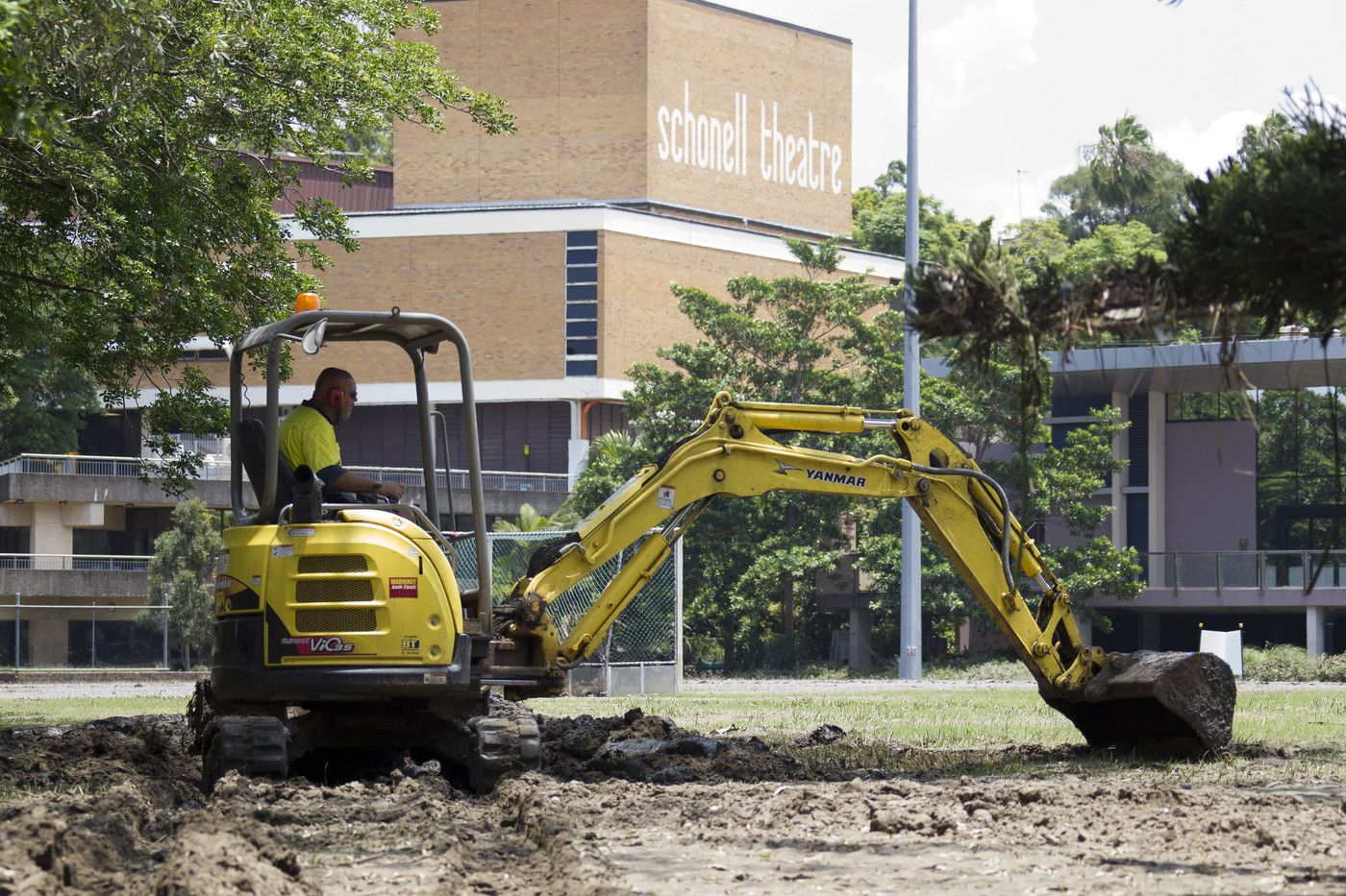 An image of a worker using an excavator near the Schonell Theatre.