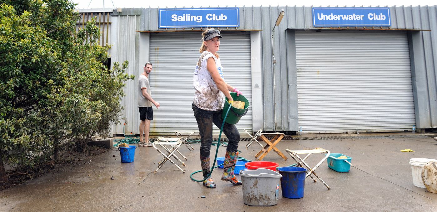An image of Volunteers cleaning up the damage at the UQ Sailing Club.