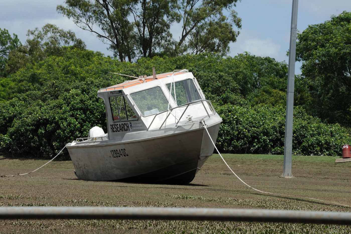 An image of a boat left stranded on the St Lucia campus after the floods.