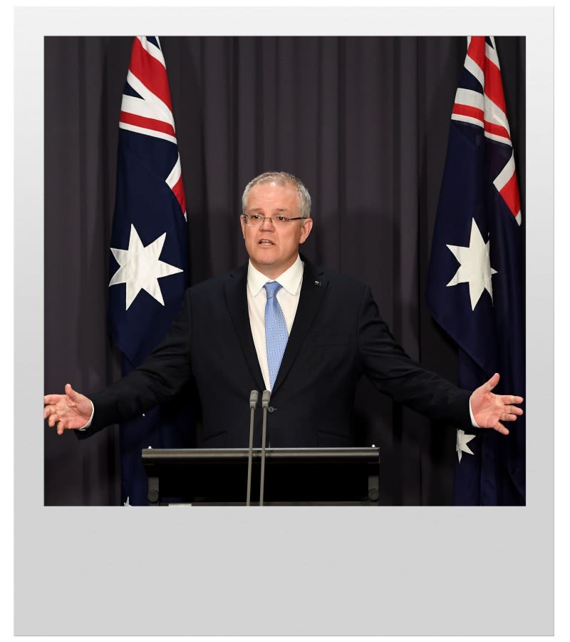 Prime Minister Scott Morrison on a podium in front of two Australian flags