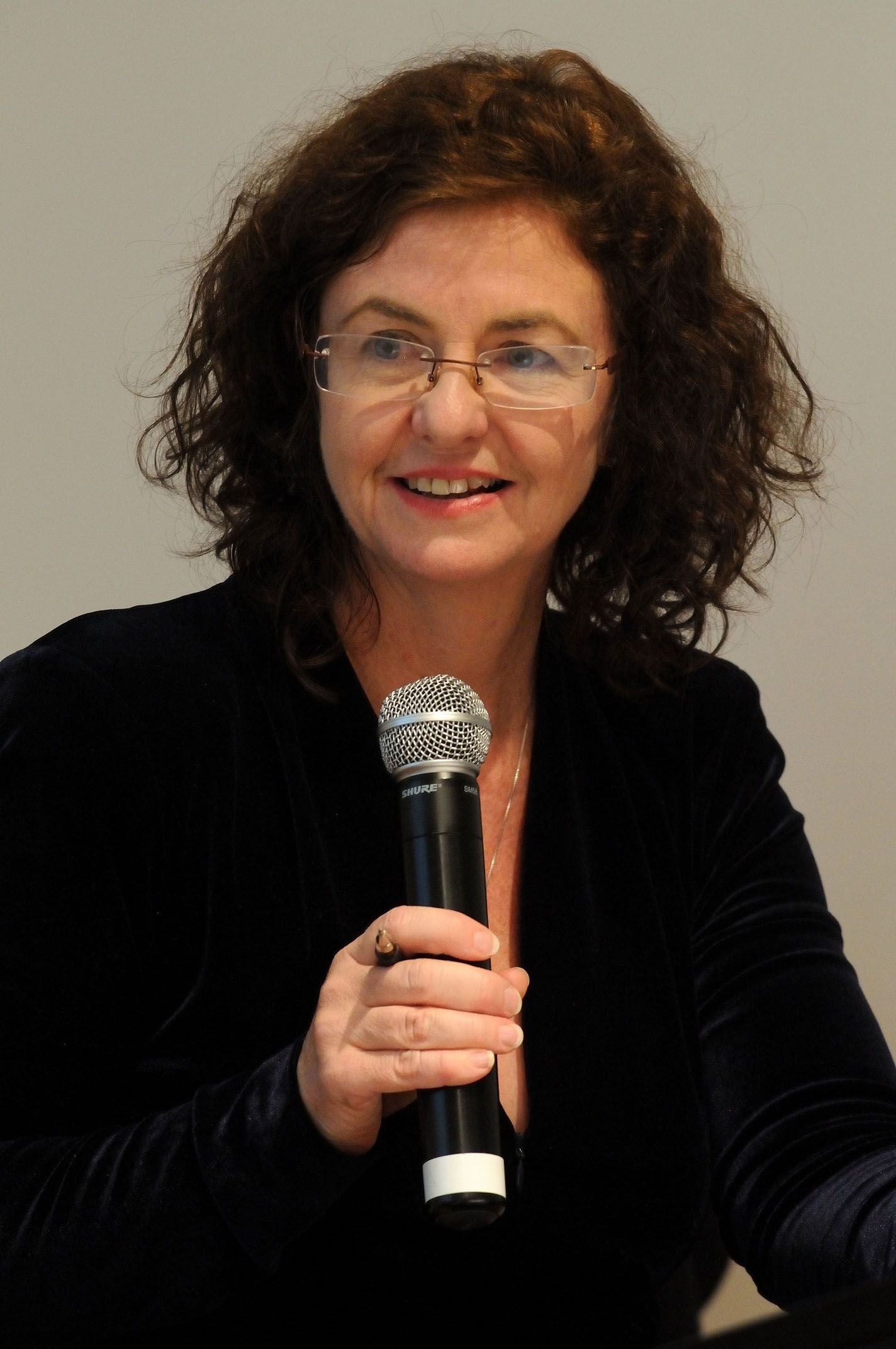 Madonna King holding a microphone